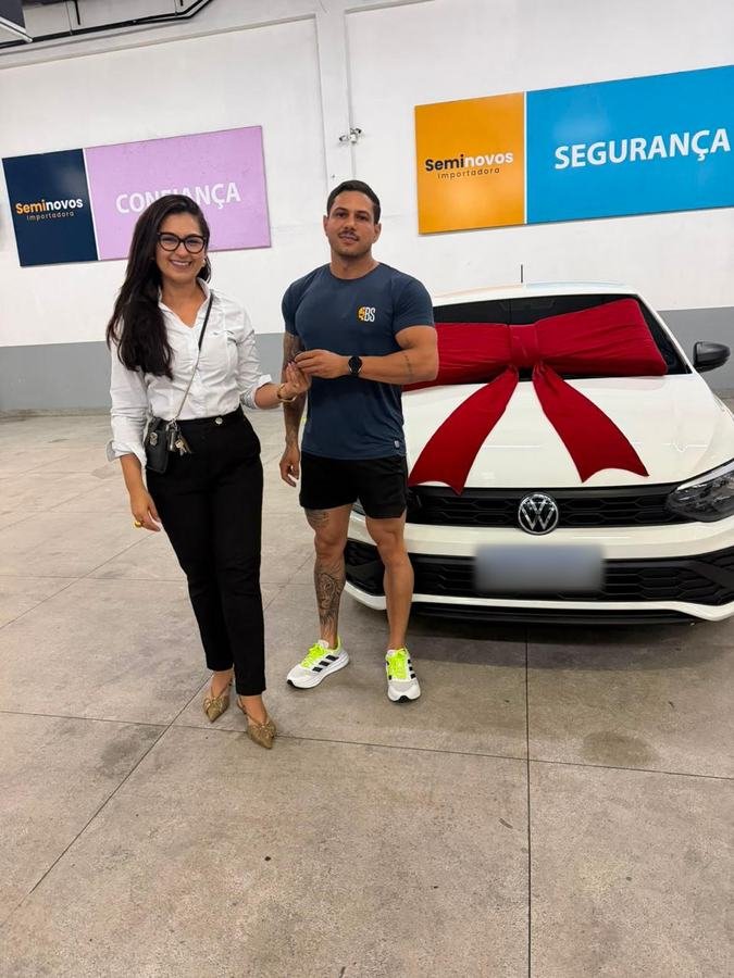 Mariana entregando a chave de um Volkswagen branco a um cliente